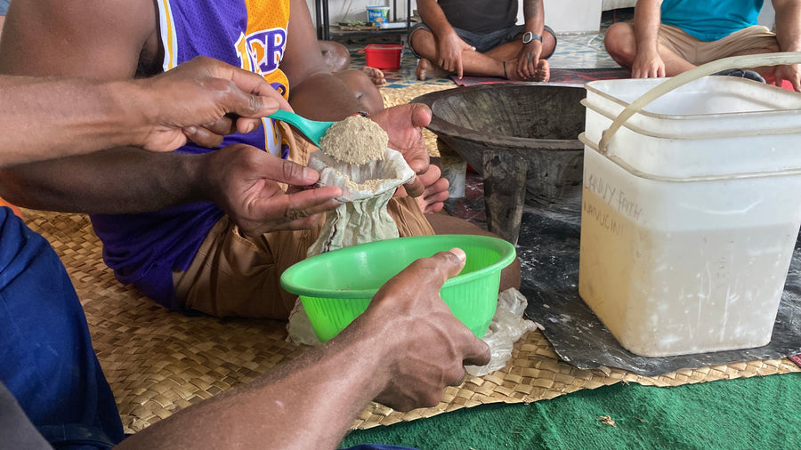 Kava root and a traditional bowl beside a Leilo can