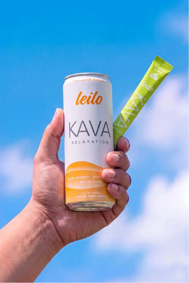 Leilo kava tonic held against a blue sky